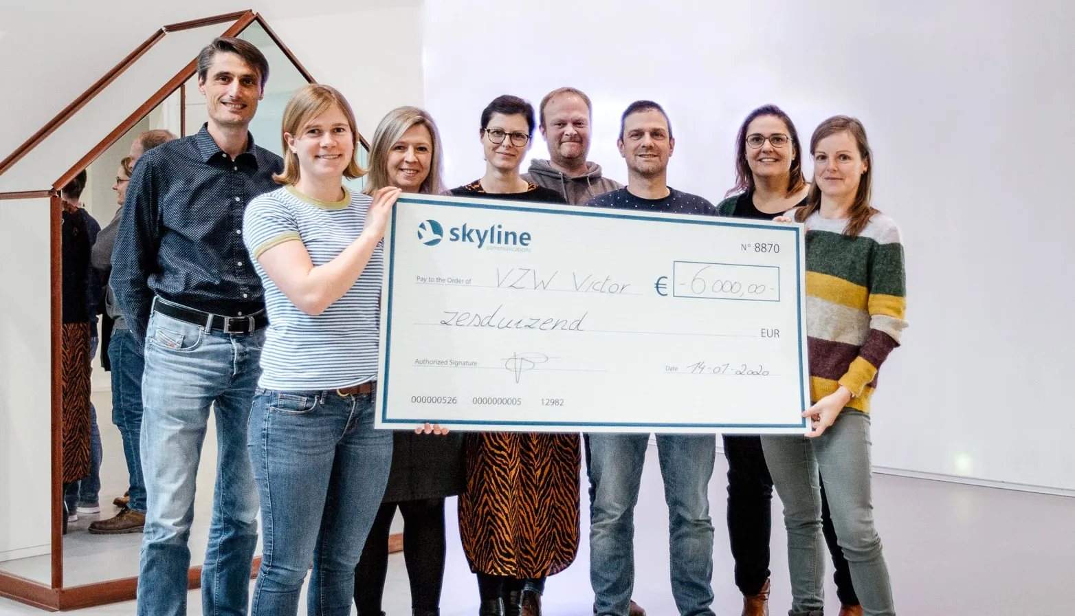 Volunteers holding a cheque of €6000 for a charity cause.
